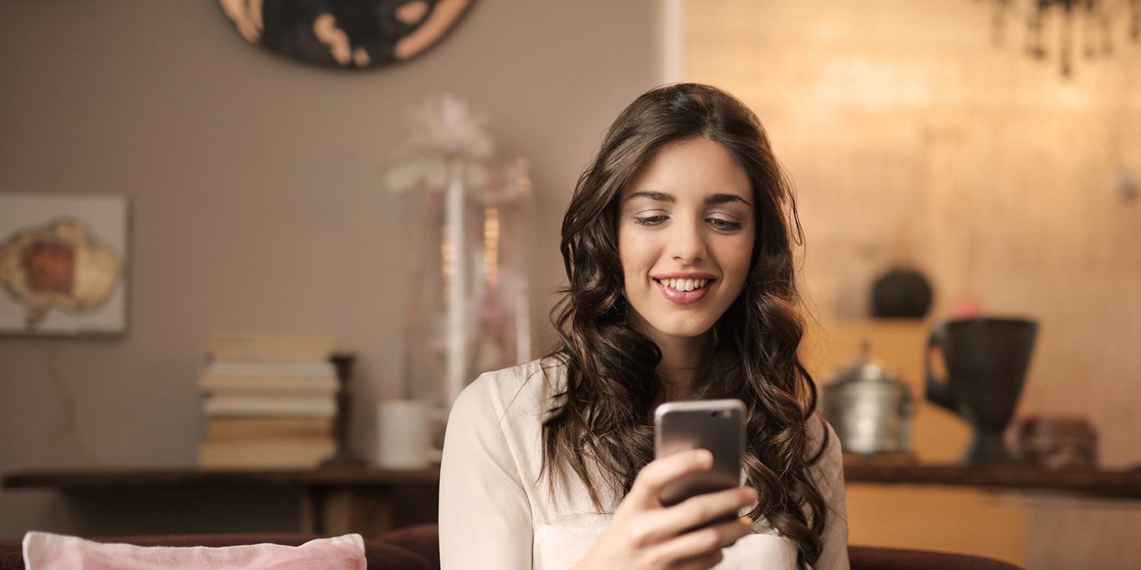 Customer using her phone at home